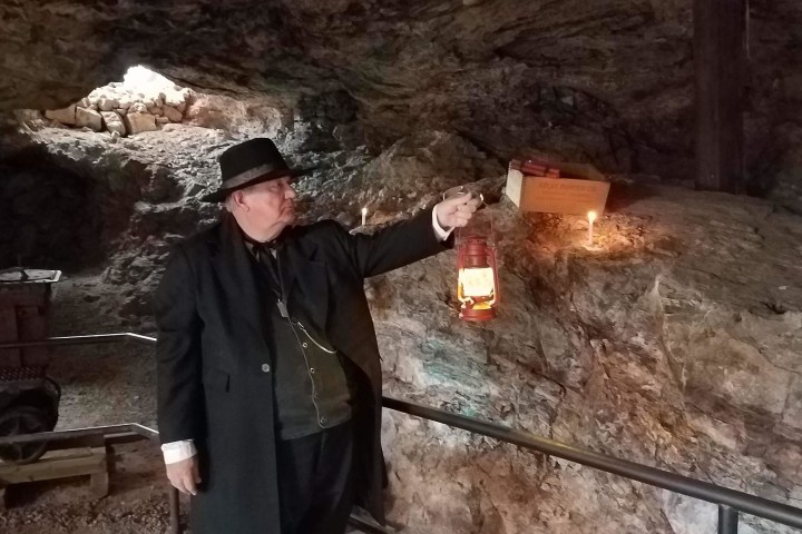 a person standing in front of a rock